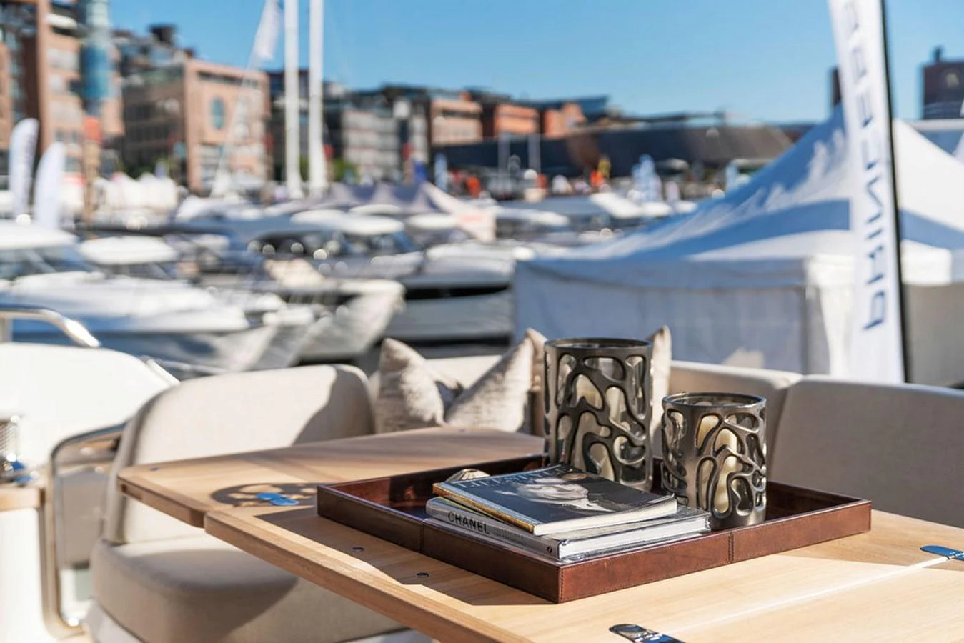 The yacht features a stylish outdoor dining area with a view of the marina. aboard PRINCESS S72 Yacht for Sale
