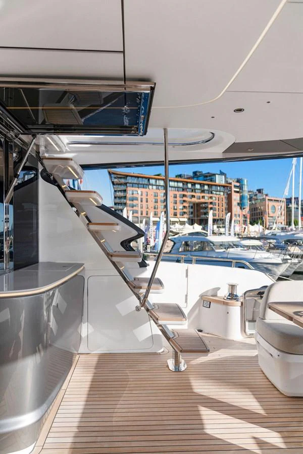 The aft deck features a sleek staircase and comfortable seating area, perfect for relaxation and socializing. aboard PRINCESS S72 Yacht for Sale