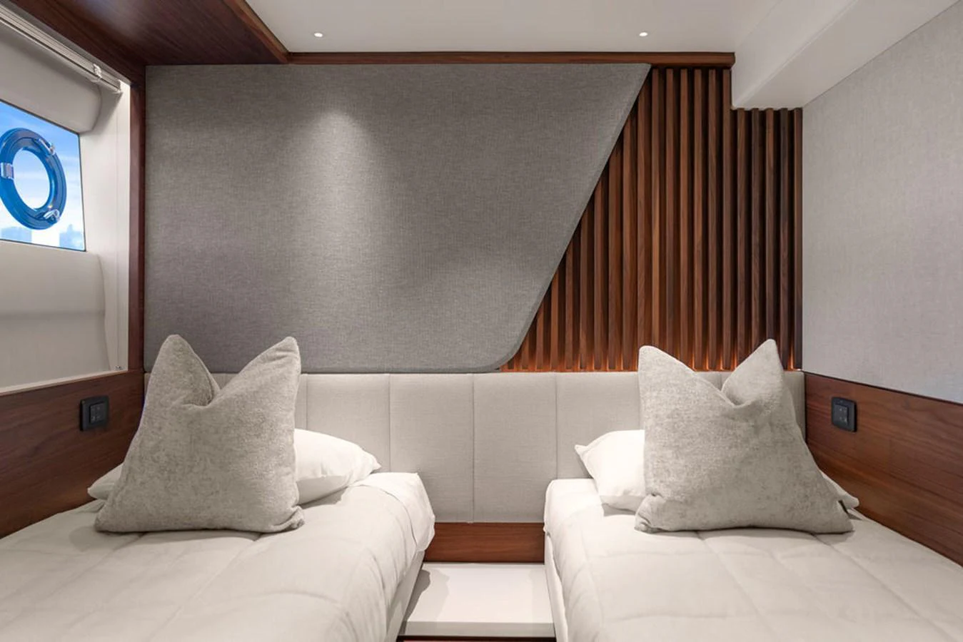 The guest stateroom features twin beds with plush pillows and modern wood paneling. aboard PRINCESS S72 Yacht for Sale