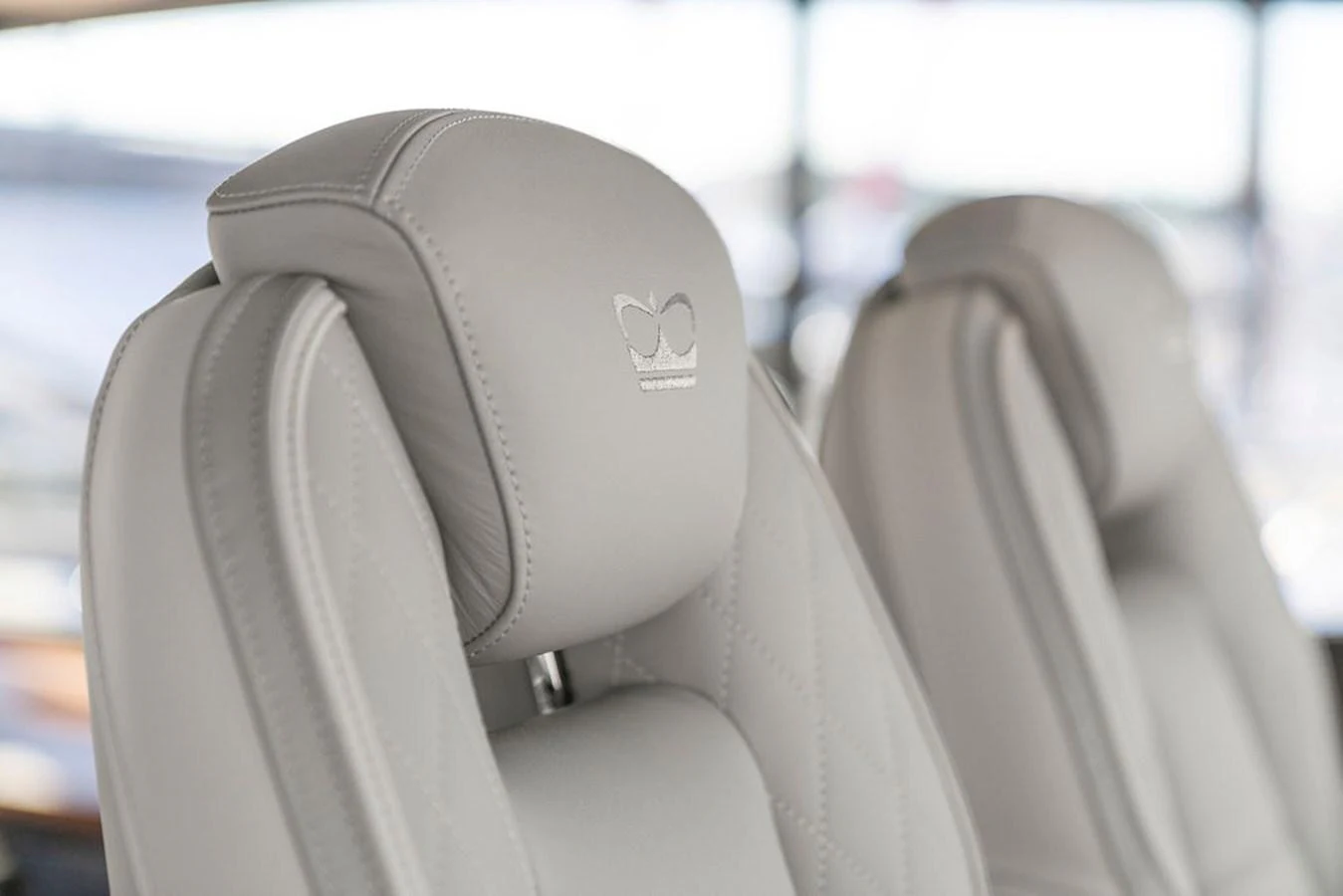 The image showcases luxurious, quilted leather seats with elegant stitching and a crown emblem. aboard PRINCESS S72 Yacht for Sale