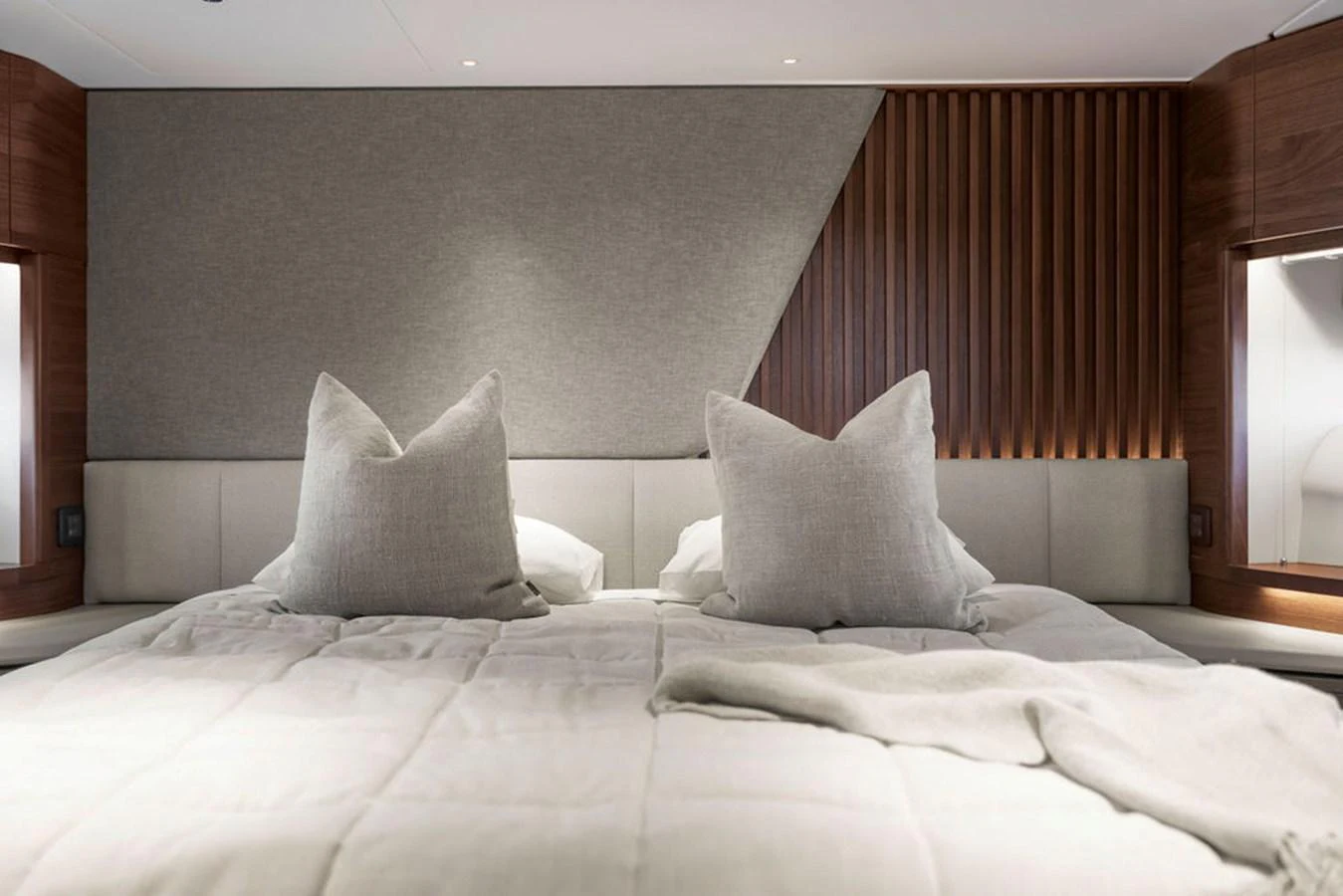 The stateroom features a plush bed with elegant pillows and modern wall accents. aboard PRINCESS S72 Yacht for Sale