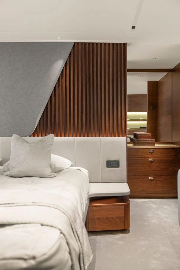 The stateroom features elegant wood paneling and a plush bed, creating a serene and luxurious retreat. aboard PRINCESS S72 Yacht for Sale