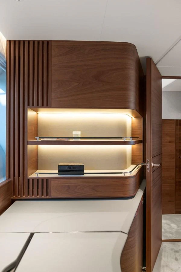 The yacht's interior features a sleek, modern design with wooden cabinetry and ambient lighting. aboard PRINCESS S72 Yacht for Sale