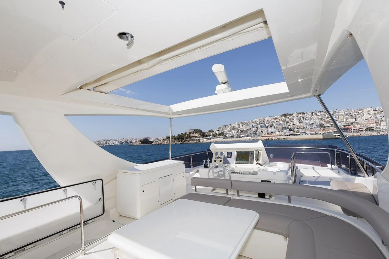 The flybridge offers a spacious and open area with comfortable seating and a stunning view of the coastline. aboard M/Y EM- II Yacht for Sale