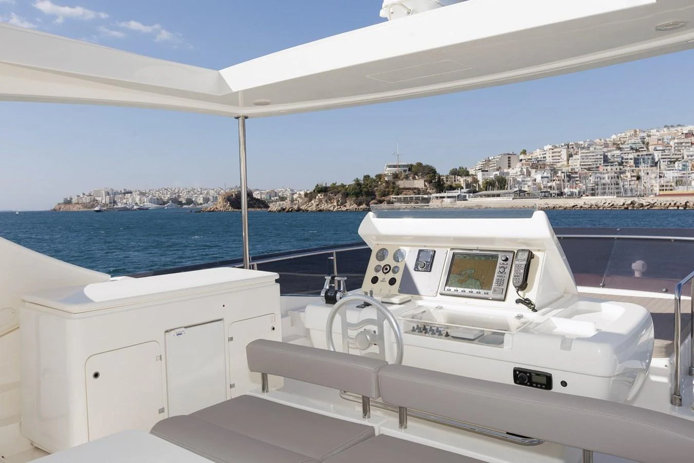 The yacht's helm offers a sophisticated navigation area with a stunning view of the coastline. aboard M/Y EM- II Yacht for Sale