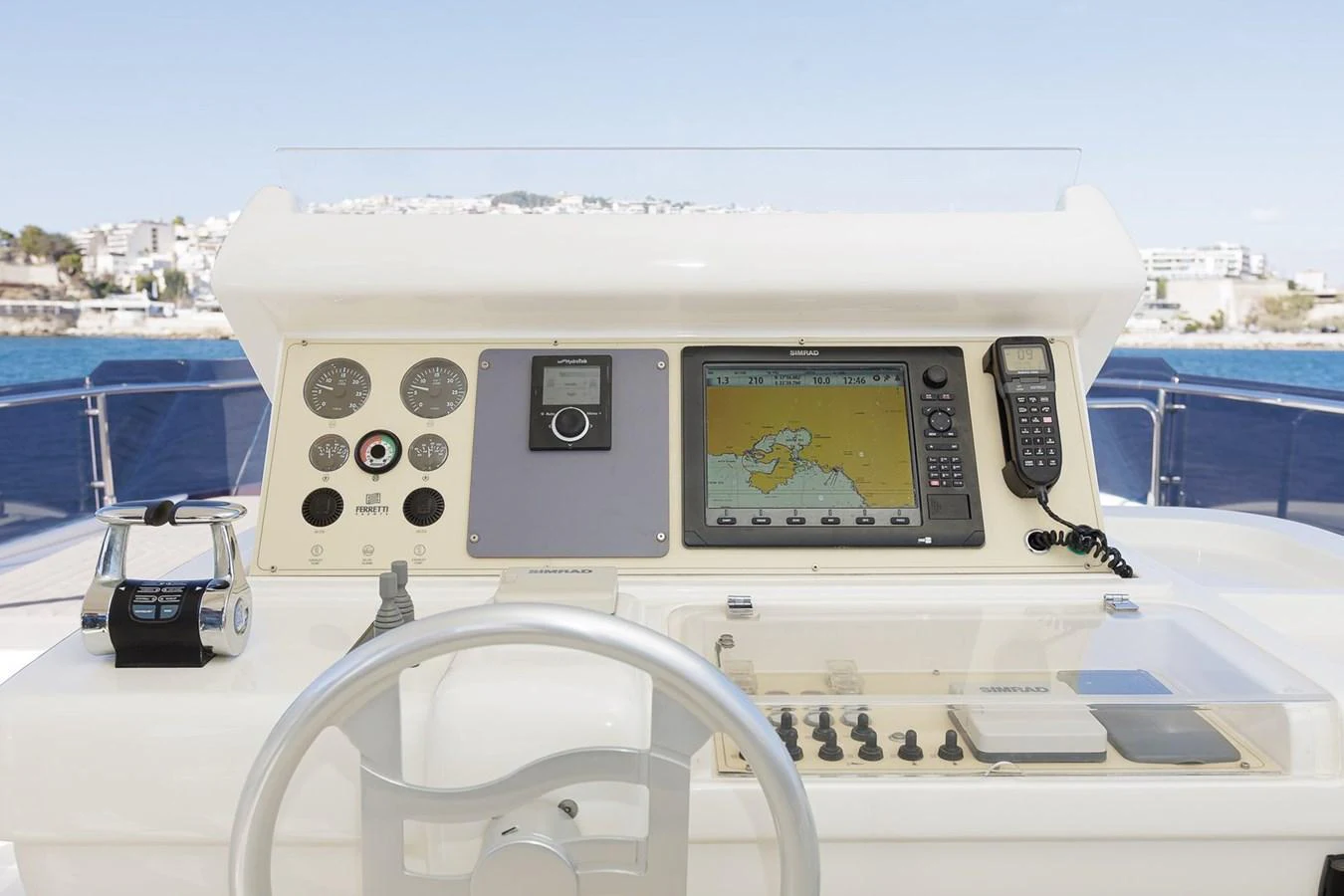 The helm station features modern navigation equipment and controls with a scenic backdrop. aboard M/Y EM- II Yacht for Sale