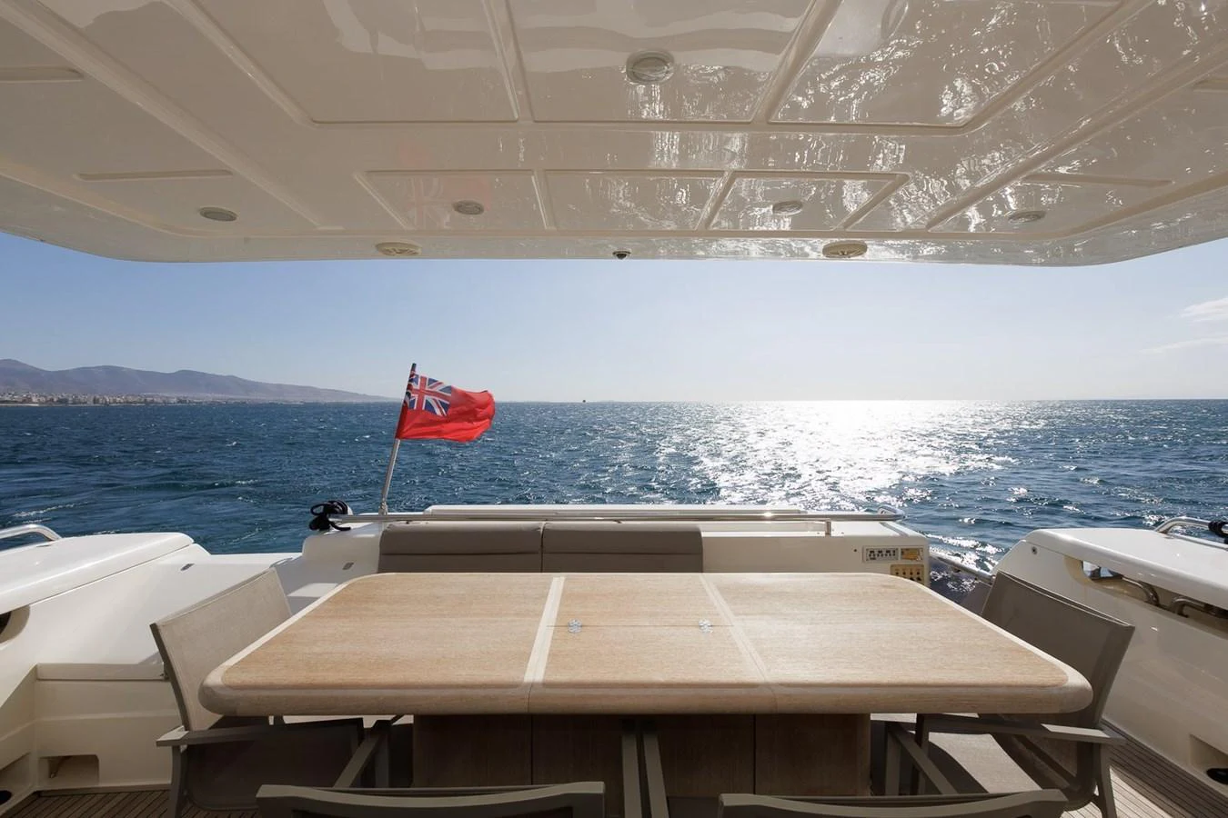 The aft deck features a spacious dining area with a stunning view of the open sea. aboard M/Y EM- II Yacht for Sale