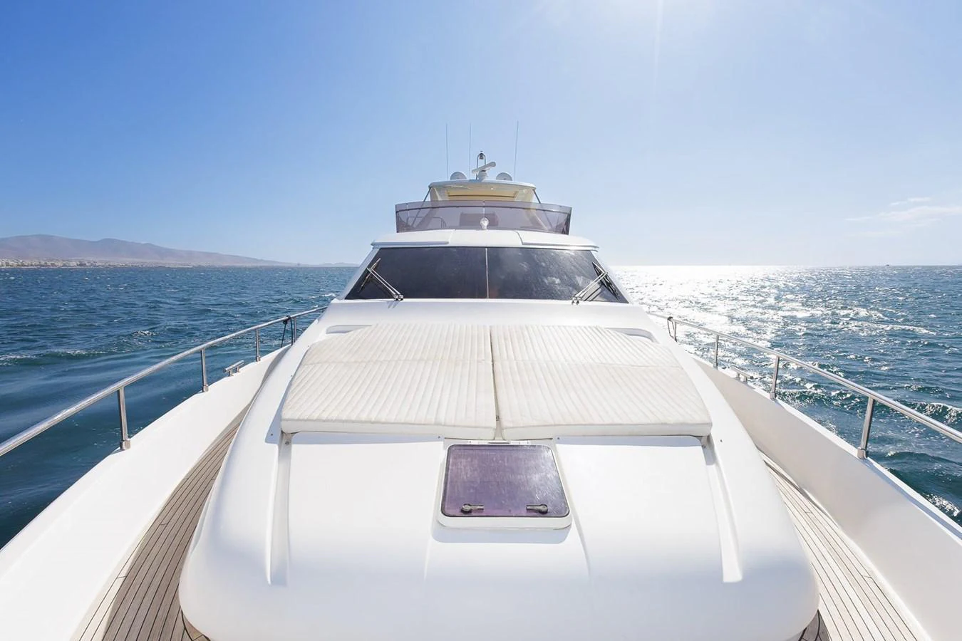 A sleek yacht cruising on open waters under a clear blue sky. aboard M/Y EM- II Yacht for Sale