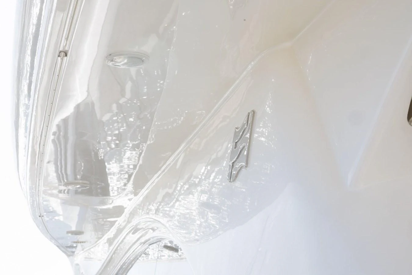 A close-up view of the sleek, polished hull of a yacht, showcasing its pristine finish. aboard M/Y EM- II Yacht for Sale