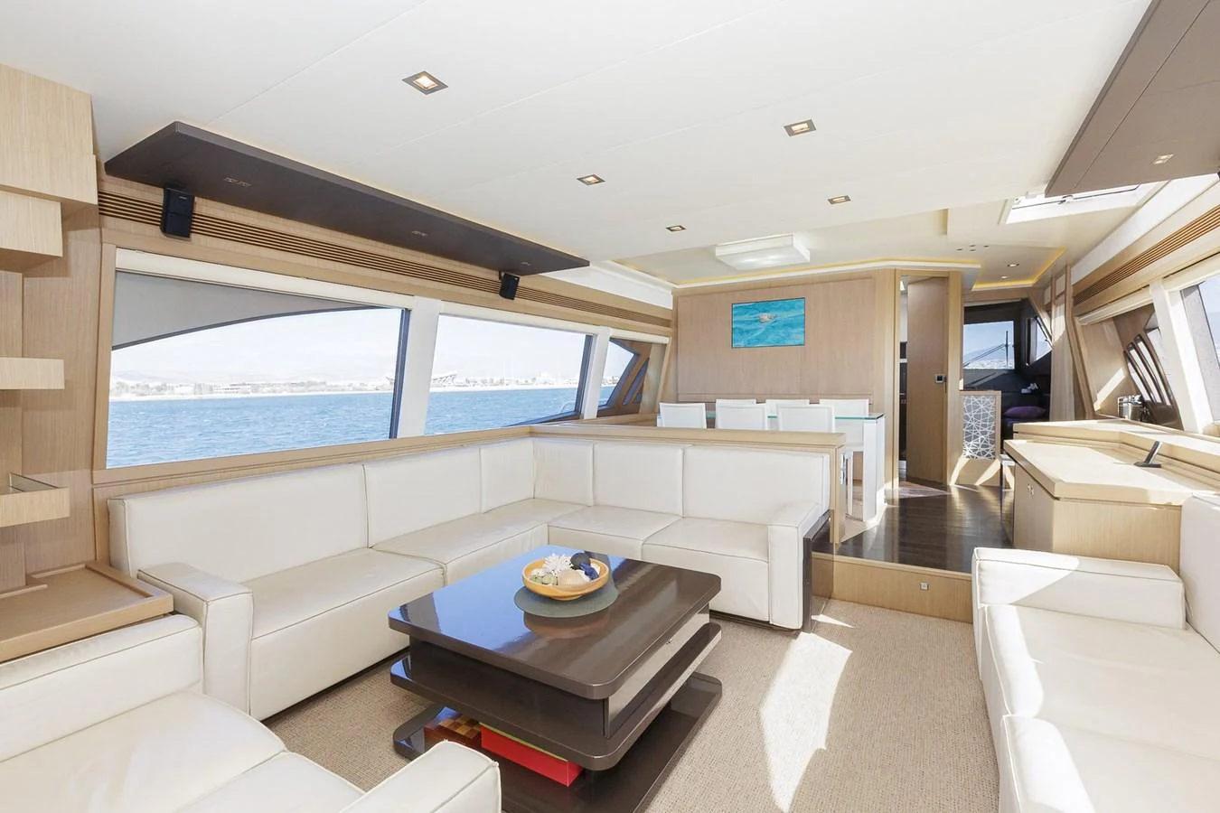 The salon features luxurious seating with panoramic windows offering stunning sea views. aboard M/Y EM- II Yacht for Sale