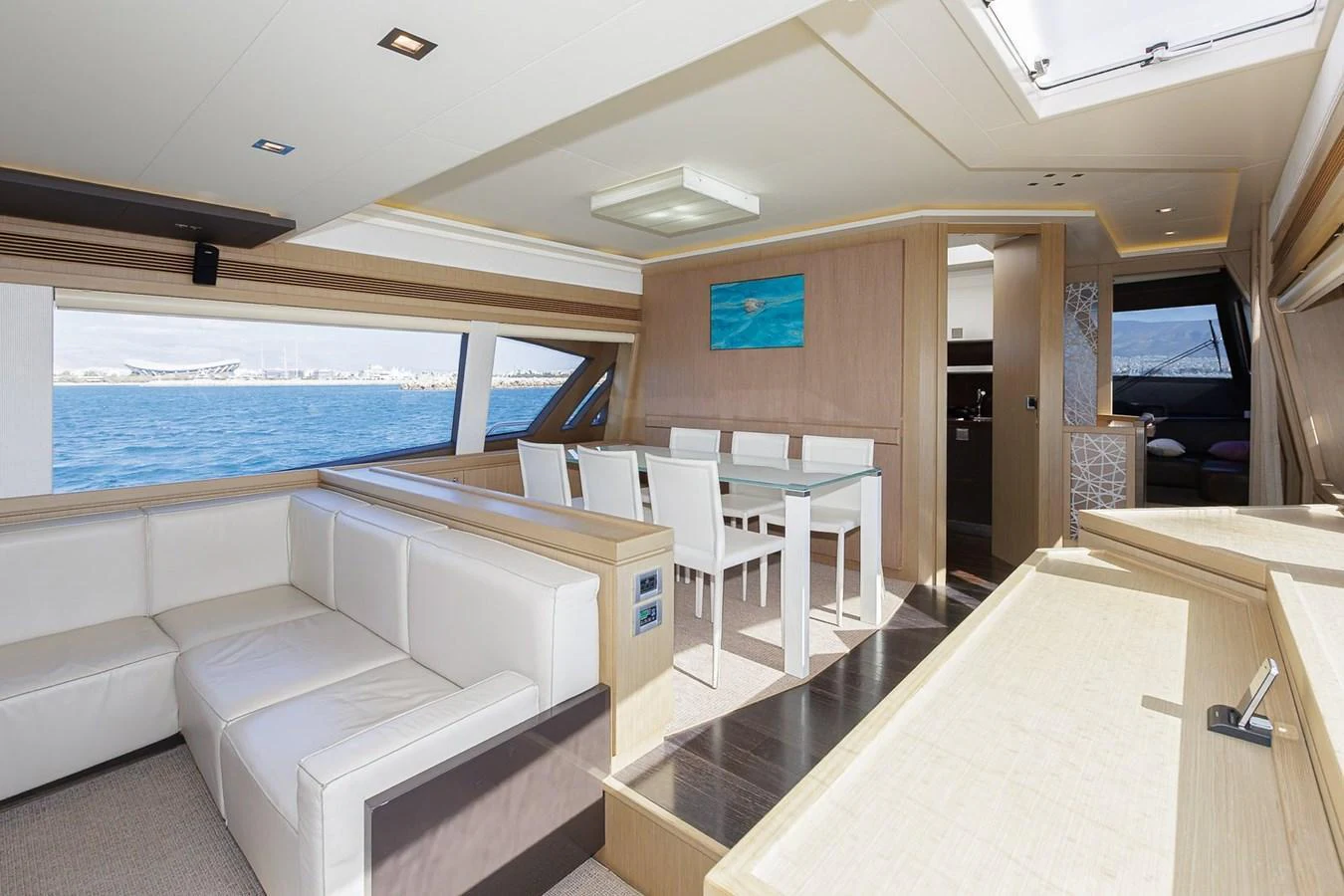 The salon features a spacious seating area with a dining table and panoramic windows offering stunning sea views. aboard M/Y EM- II Yacht for Sale
