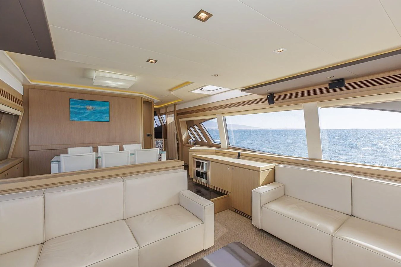 The yacht's salon features luxurious seating with panoramic ocean views through large windows. aboard M/Y EM- II Yacht for Sale