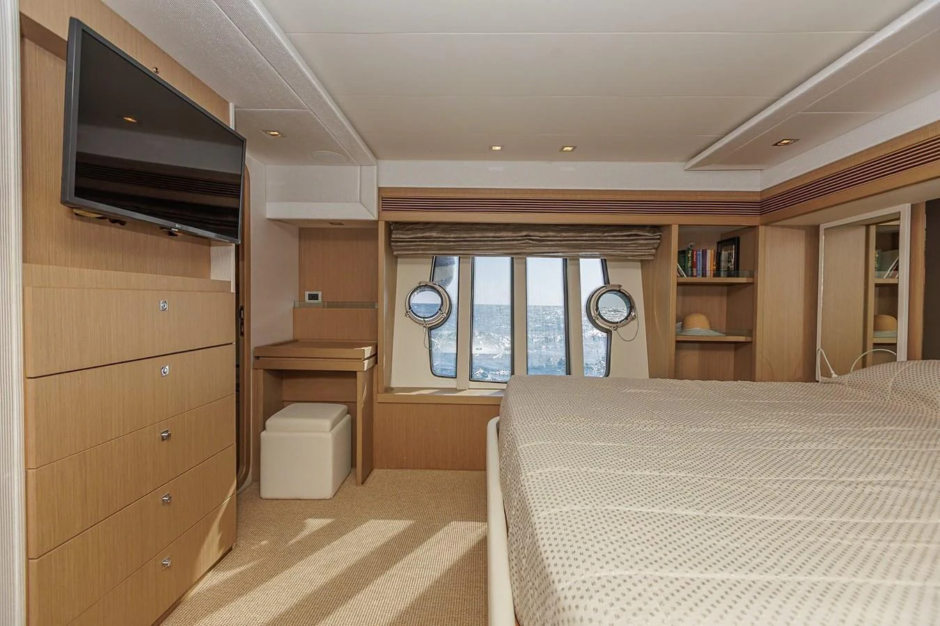 The stateroom features a comfortable bed, a flat-screen TV, and ample storage space, creating a cozy and functional retreat. aboard M/Y EM- II Yacht for Sale