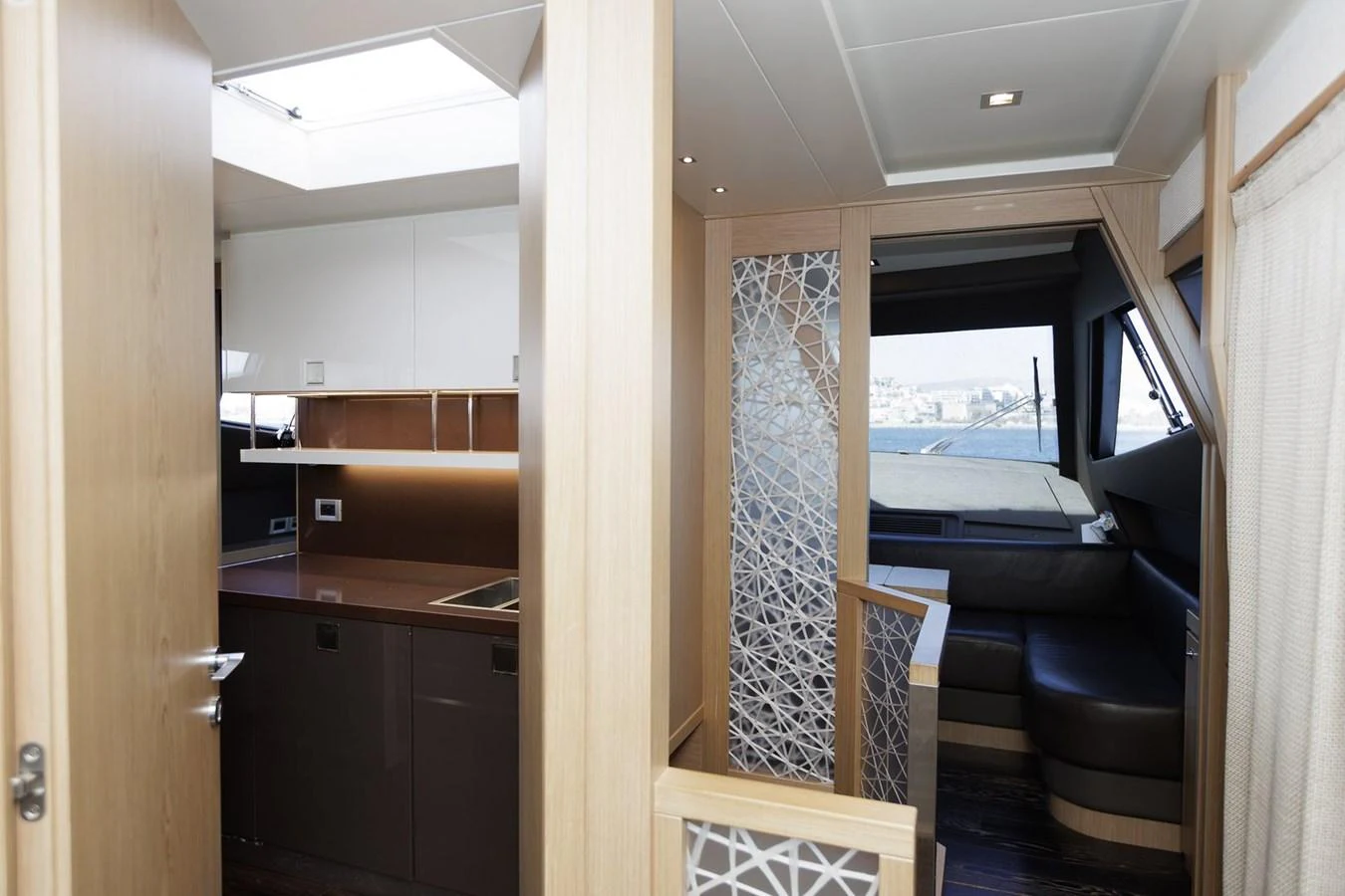 The yacht's interior features a modern and stylish design with a cozy seating area and a well-equipped galley. aboard M/Y EM- II Yacht for Sale