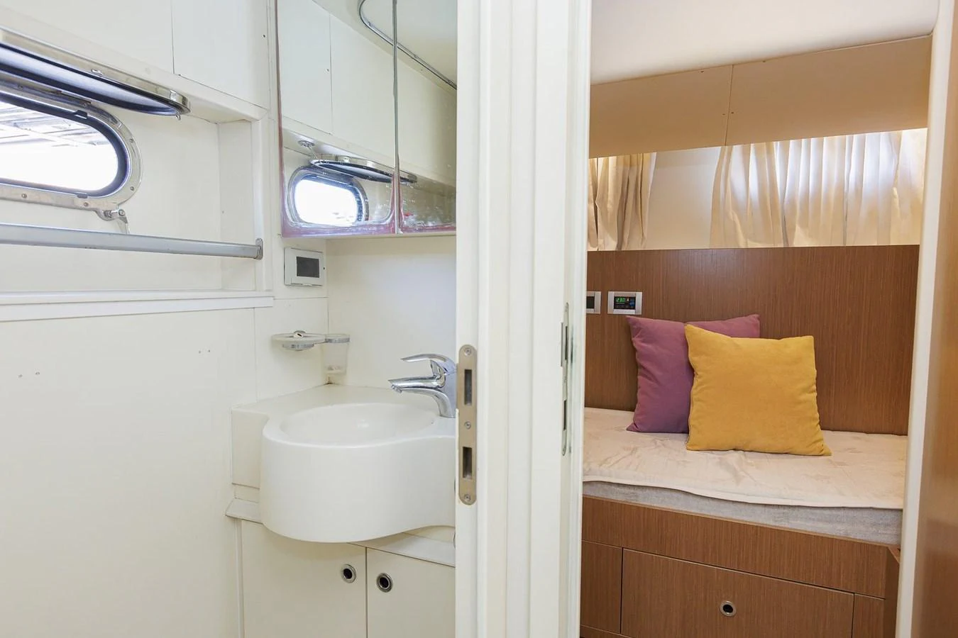 A cozy guest stateroom with an adjacent bathroom, featuring a comfortable bed and modern fixtures. aboard M/Y EM- II Yacht for Sale