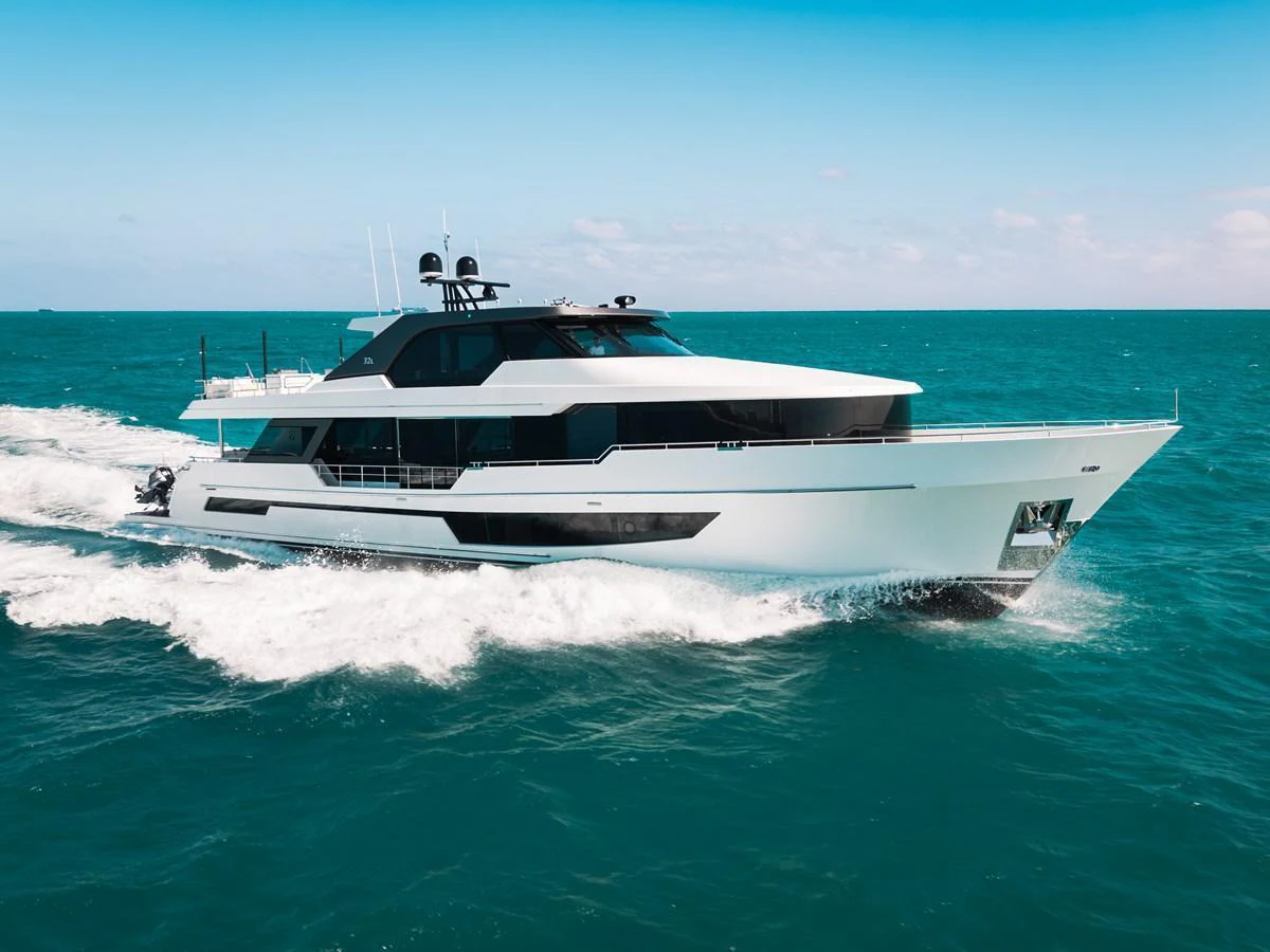 A sleek and modern yacht cruising through clear blue waters under a bright sky. aboard LA LA LA Yacht for Sale