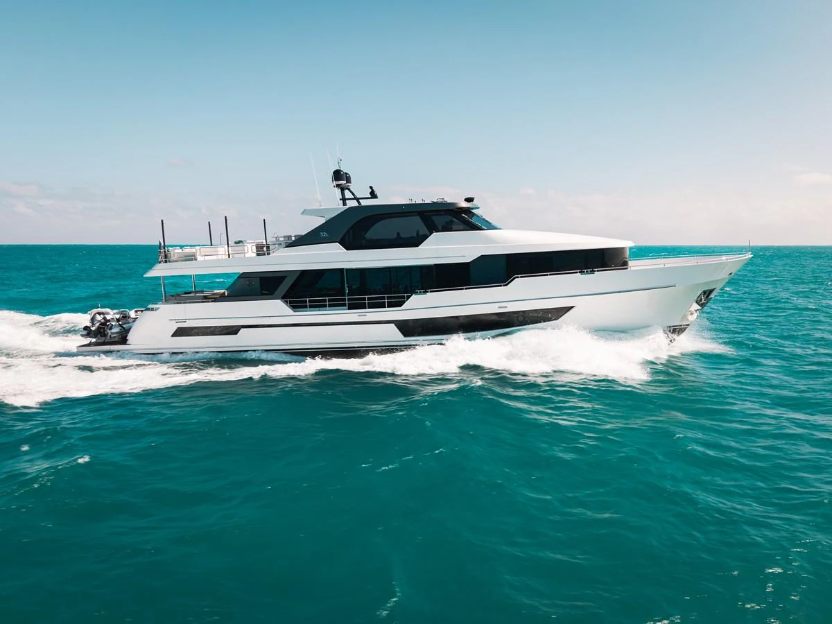 A sleek and modern yacht cruises swiftly through turquoise waters under a clear sky. aboard LA LA LA Yacht for Sale
