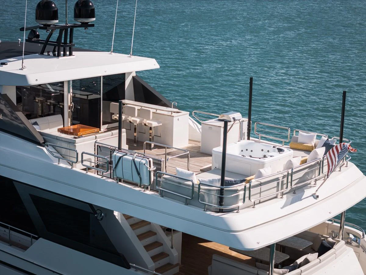 The yacht's sundeck features a luxurious hot tub and ample seating, perfect for relaxation and entertaining. aboard LA LA LA Yacht for Sale