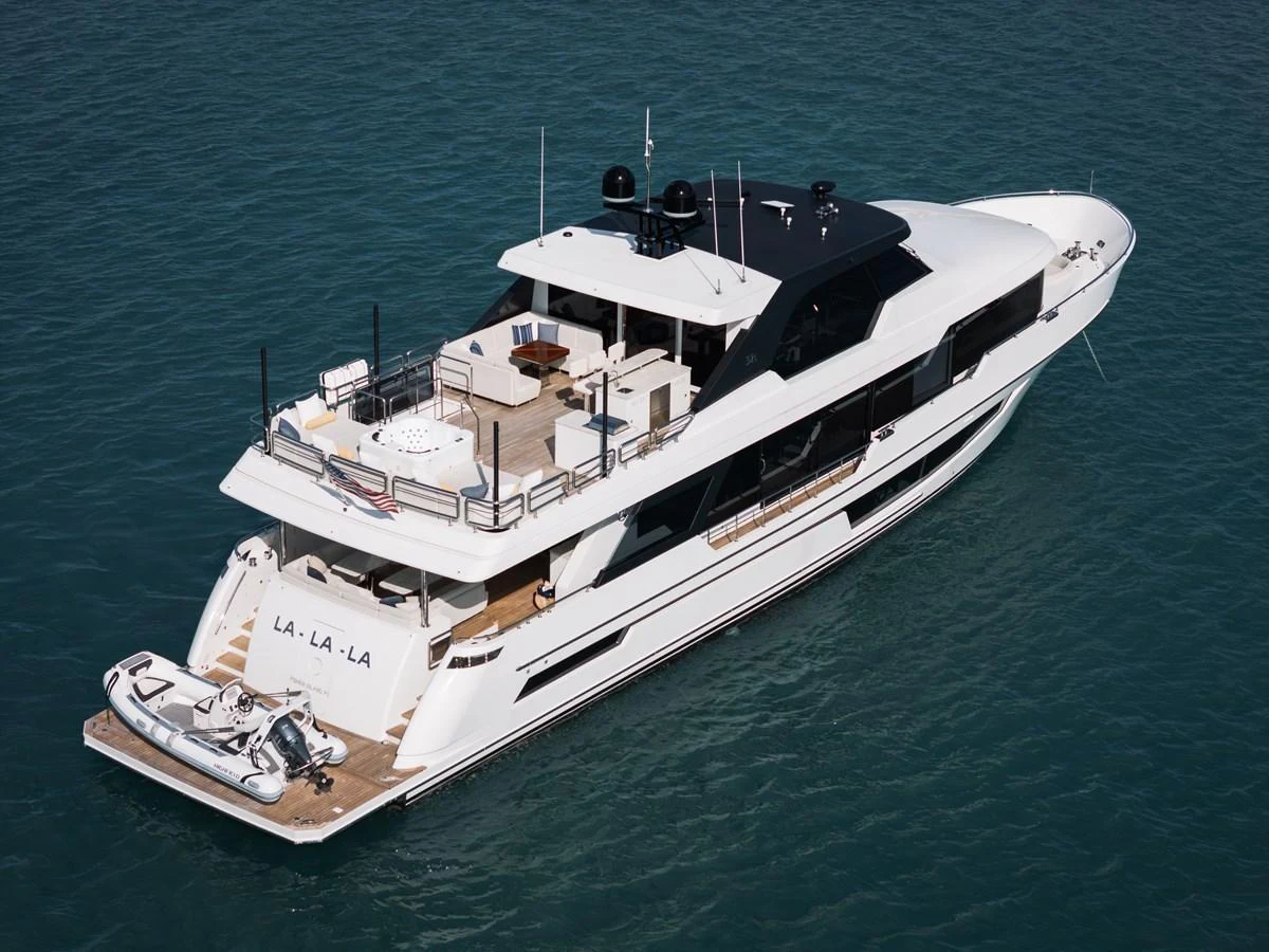 A sleek and modern yacht cruising on calm waters, showcasing its luxurious amenities and elegant design. aboard LA LA LA Yacht for Sale