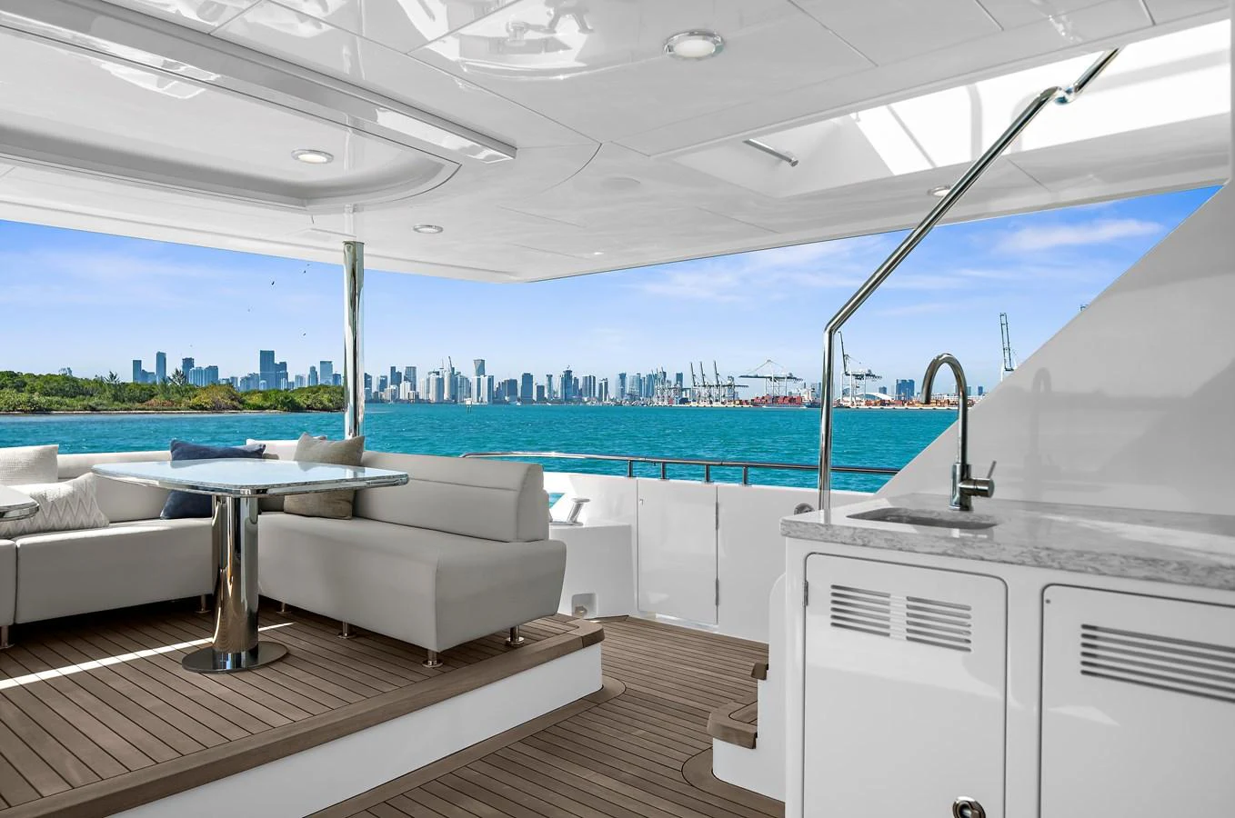 The aft deck offers a luxurious seating area with stunning views of the city skyline. aboard LA LA LA Yacht for Sale