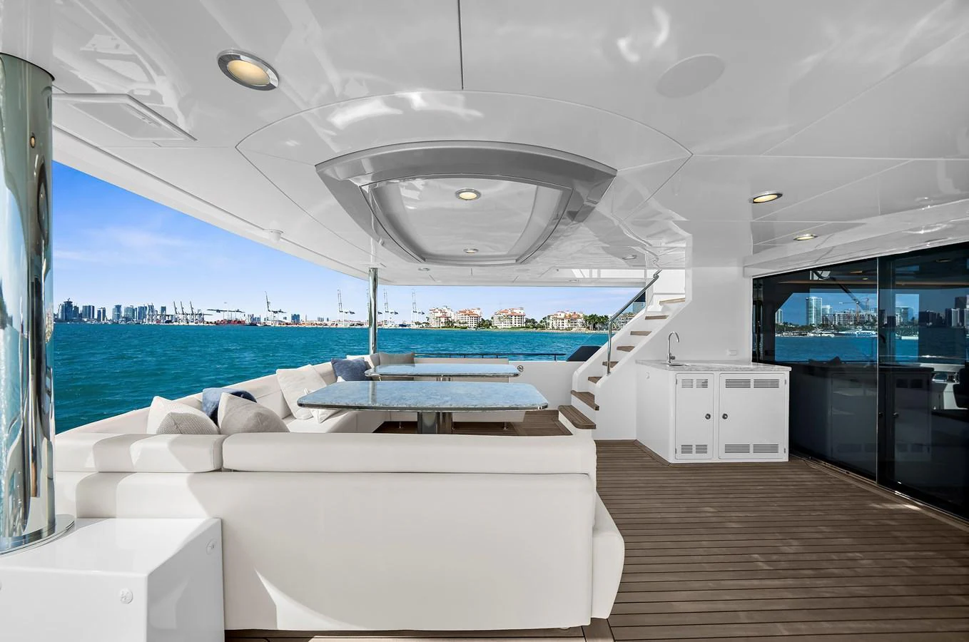 The aft deck offers a luxurious outdoor seating area with stunning views of the water and city skyline. aboard LA LA LA Yacht for Sale