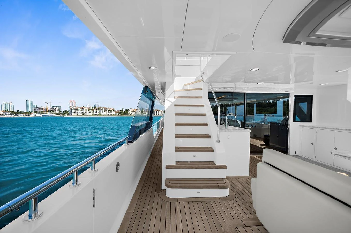 The aft deck offers a spacious and inviting area with a staircase leading to the upper deck, perfect for enjoying the sea views. aboard LA LA LA Yacht for Sale