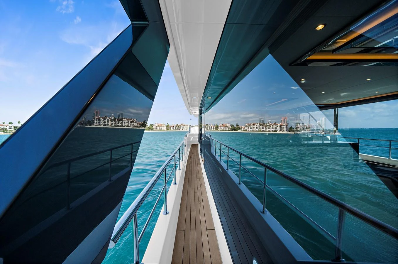 The sleek side deck offers stunning views of the surrounding waters and cityscape. aboard LA LA LA Yacht for Sale