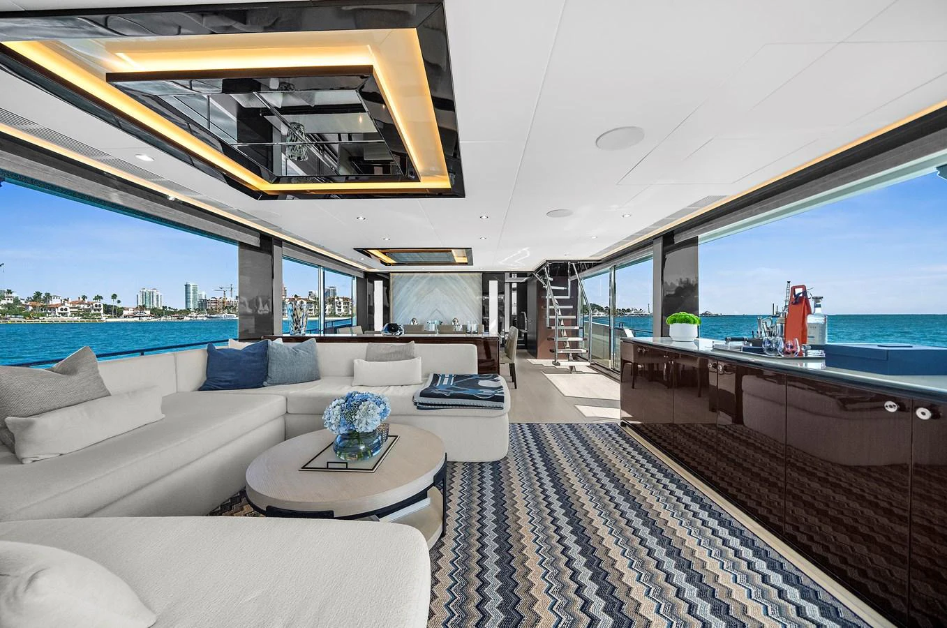 The spacious salon offers panoramic views and luxurious comfort with modern furnishings. aboard LA LA LA Yacht for Sale