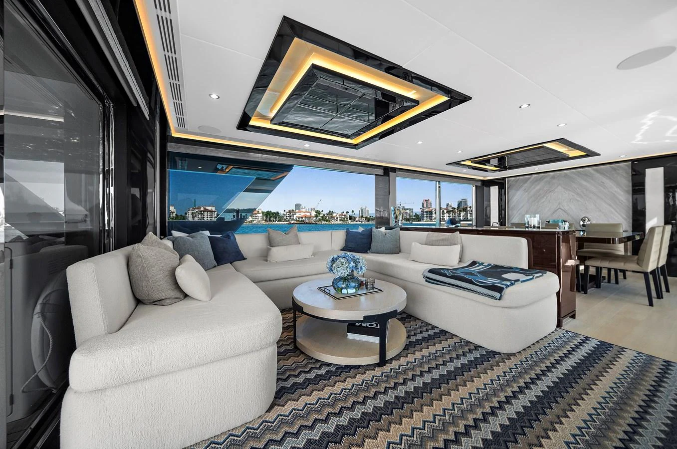 The yacht's salon features a spacious and elegantly designed seating area with modern decor and panoramic windows. aboard LA LA LA Yacht for Sale