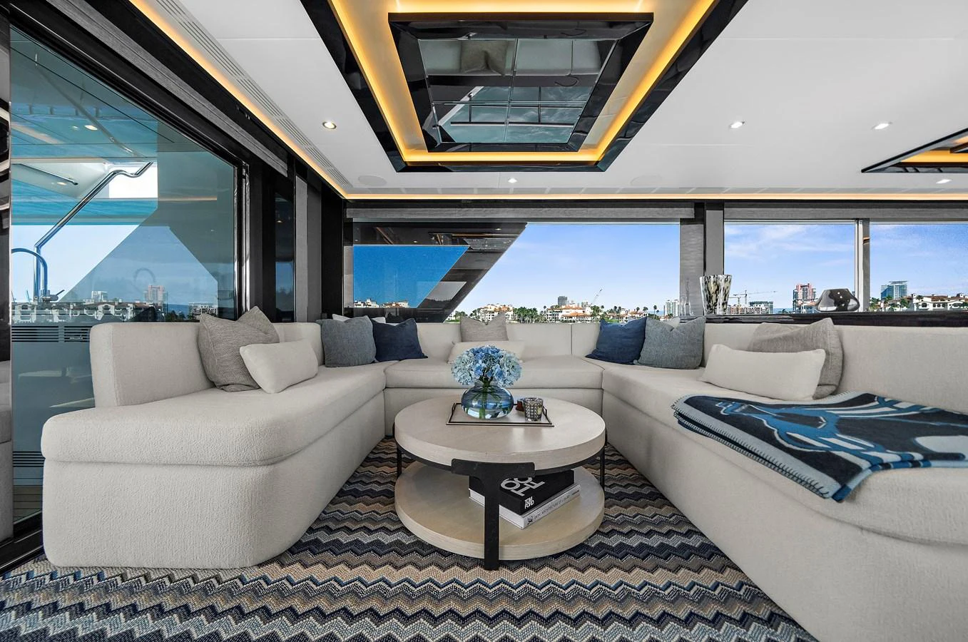 The salon features a spacious and elegant seating area with panoramic views. aboard LA LA LA Yacht for Sale