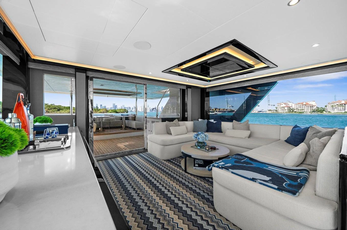 The salon offers a spacious and luxurious seating area with panoramic views of the water. aboard LA LA LA Yacht for Sale