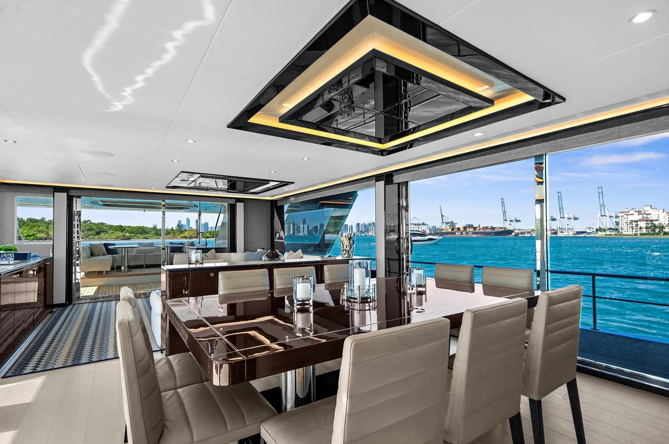 The yacht's dining area offers a luxurious setting with modern furnishings and expansive views of the water. aboard LA LA LA Yacht for Sale
