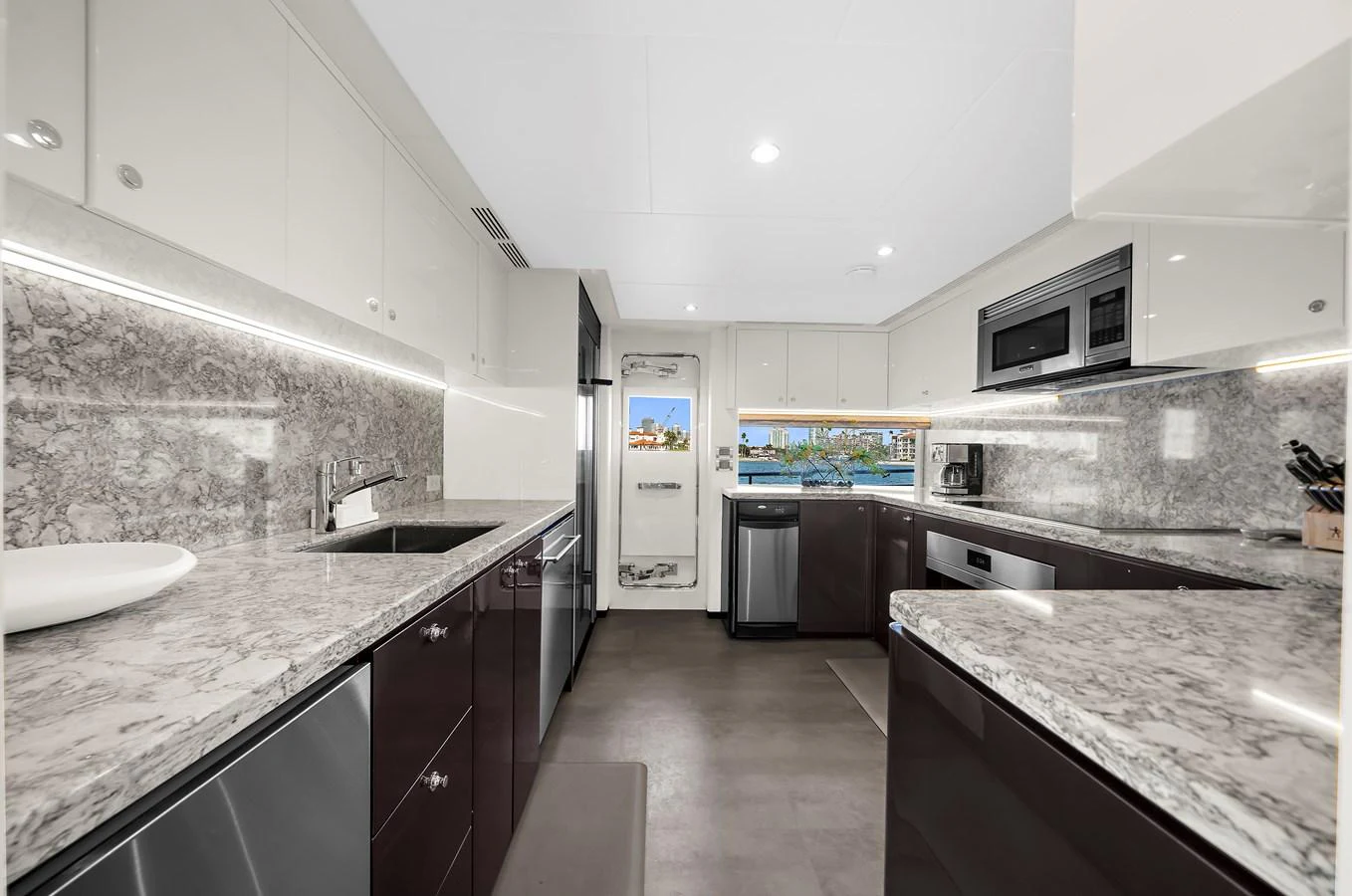 The galley features modern appliances and sleek countertops, providing a stylish and functional space for meal preparation. aboard LA LA LA Yacht for Sale