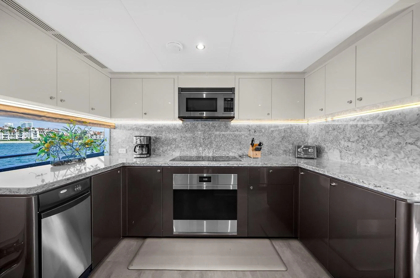 The yacht's galley features modern appliances and sleek cabinetry, offering a stylish and functional space for meal preparation. aboard LA LA LA Yacht for Sale