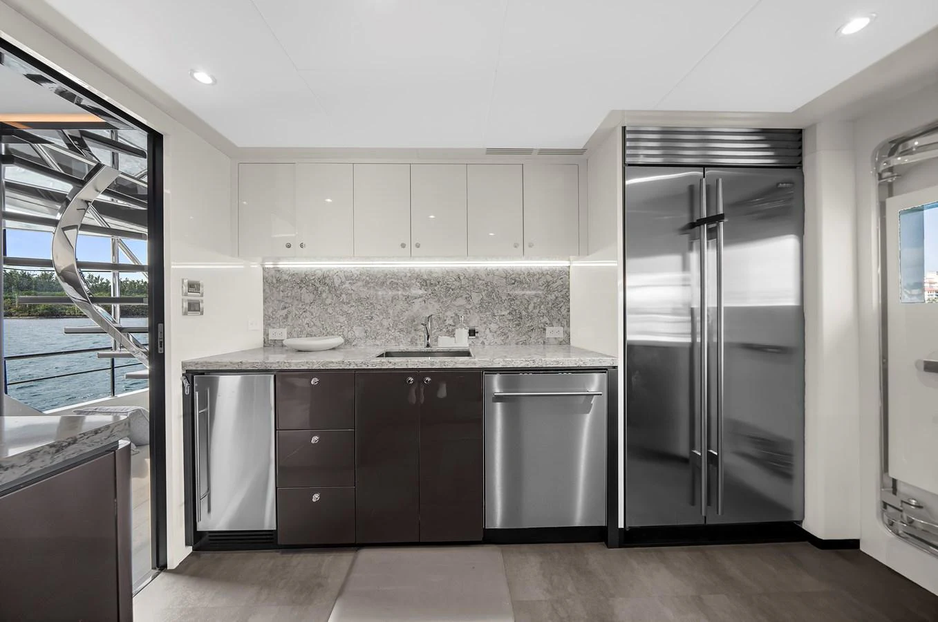 The modern galley features sleek cabinetry, stainless steel appliances, and ample counter space. aboard LA LA LA Yacht for Sale