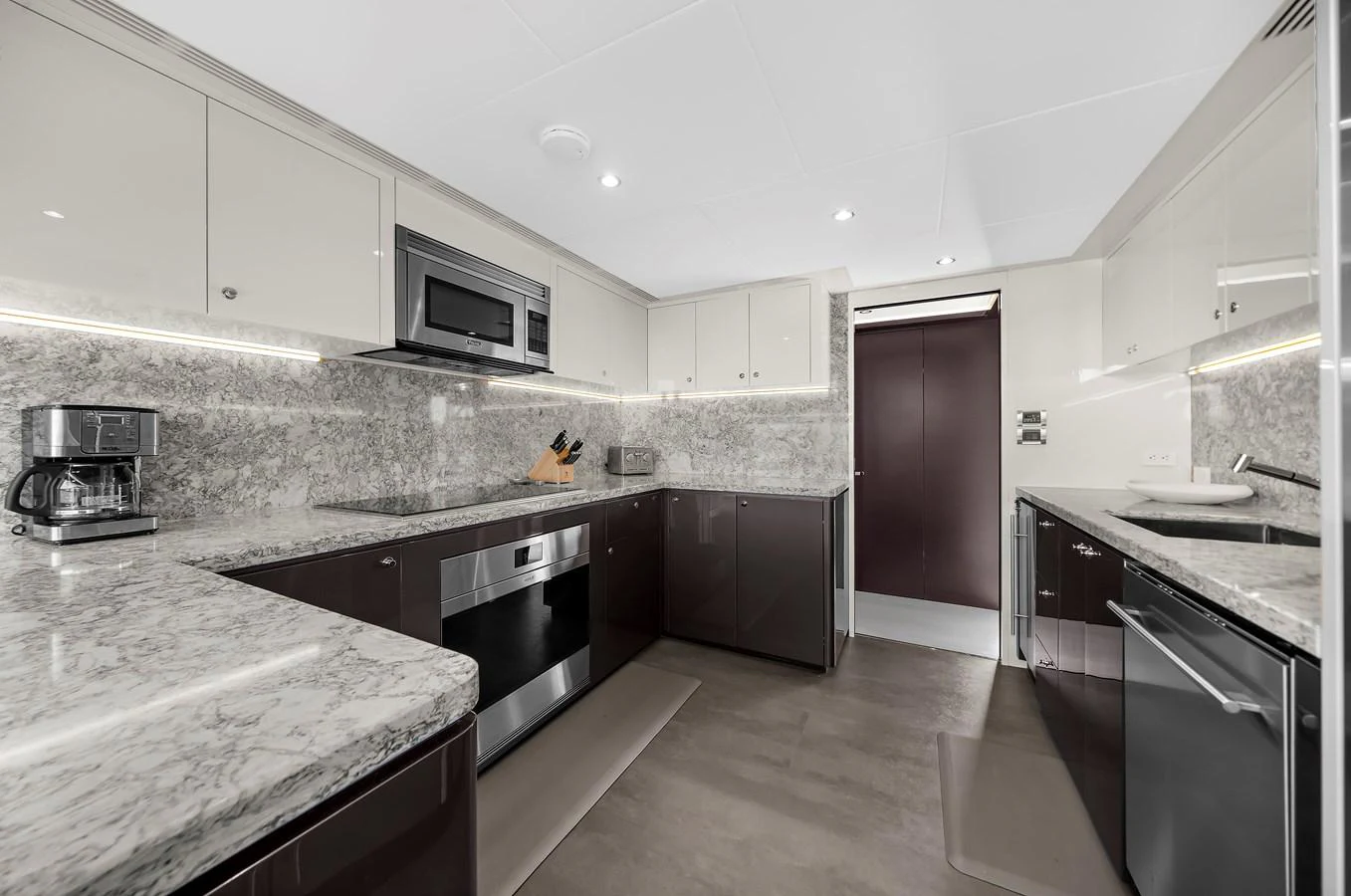 The galley features modern appliances and sleek countertops, offering a stylish and functional space for meal preparation. aboard LA LA LA Yacht for Sale