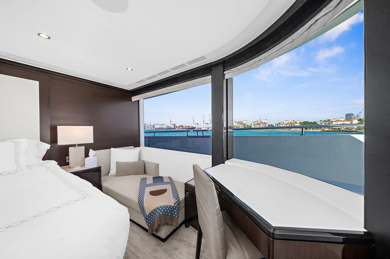 A luxurious stateroom with large windows offering a stunning view of the marina. aboard LA LA LA Yacht for Sale