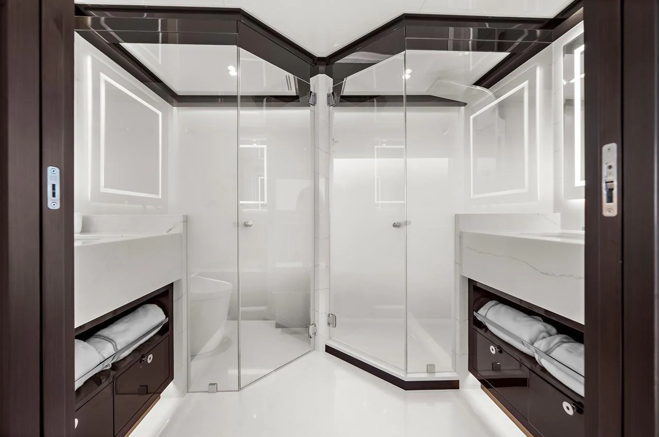 A luxurious yacht bathroom with modern glass shower enclosures and sleek design. aboard LA LA LA Yacht for Sale