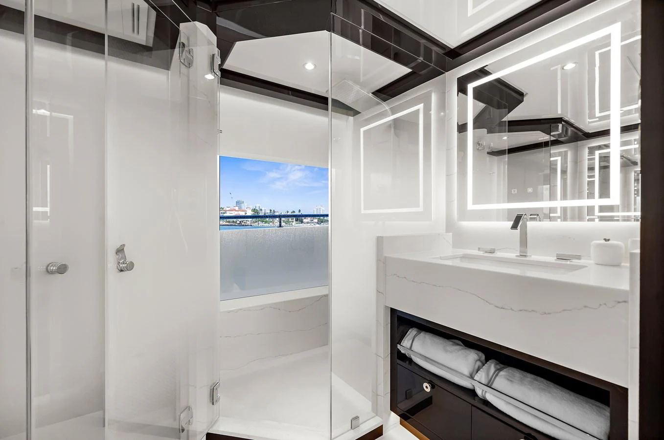 The yacht's bathroom features sleek, modern design with a spacious shower and elegant vanity. aboard LA LA LA Yacht for Sale