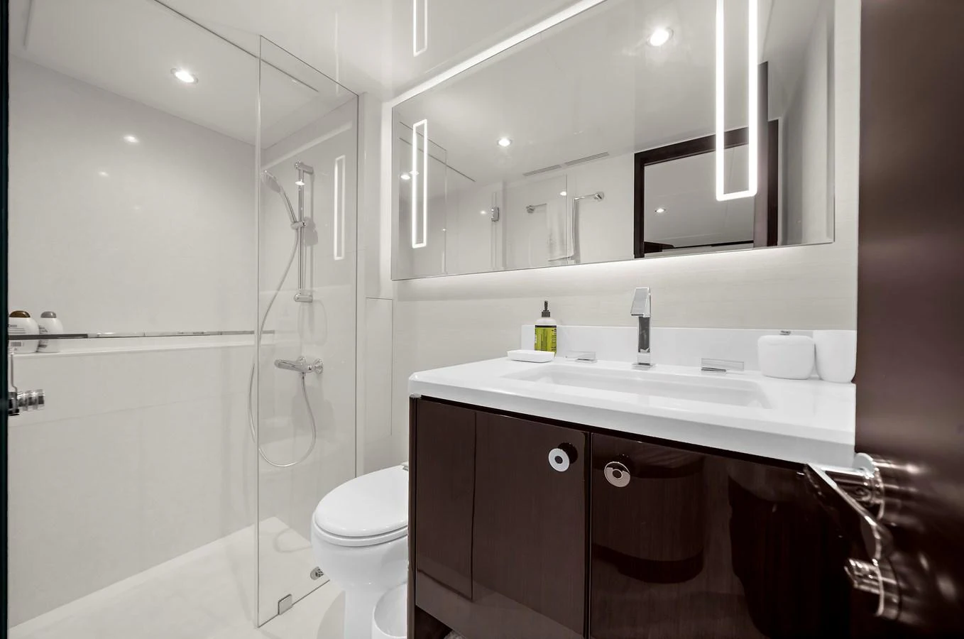 The yacht's bathroom features a sleek, modern design with a spacious shower and elegant fixtures. aboard LA LA LA Yacht for Sale