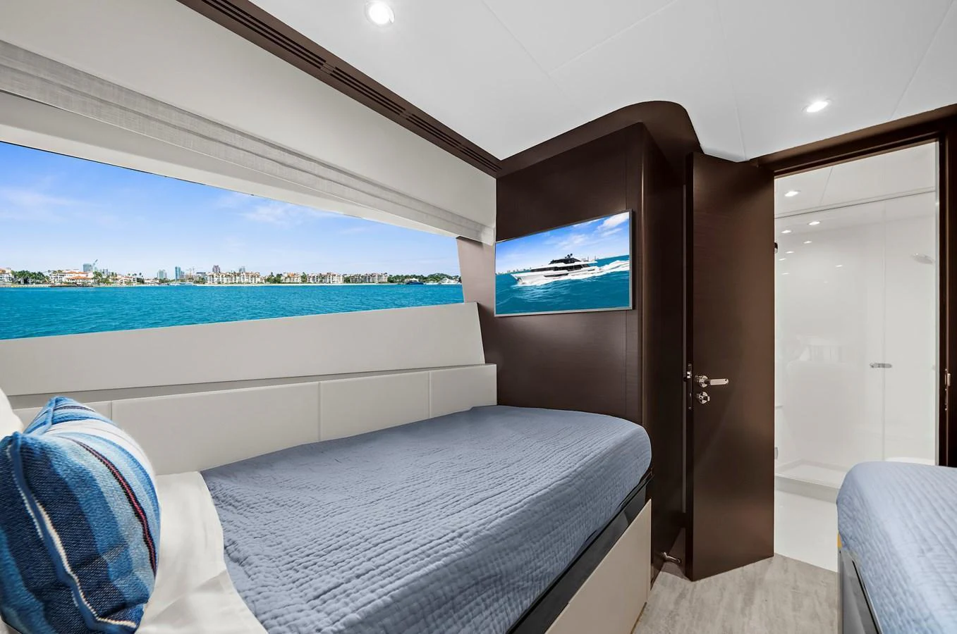 The guest stateroom offers a serene retreat with twin beds and a large window providing a stunning ocean view. aboard LA LA LA Yacht for Sale