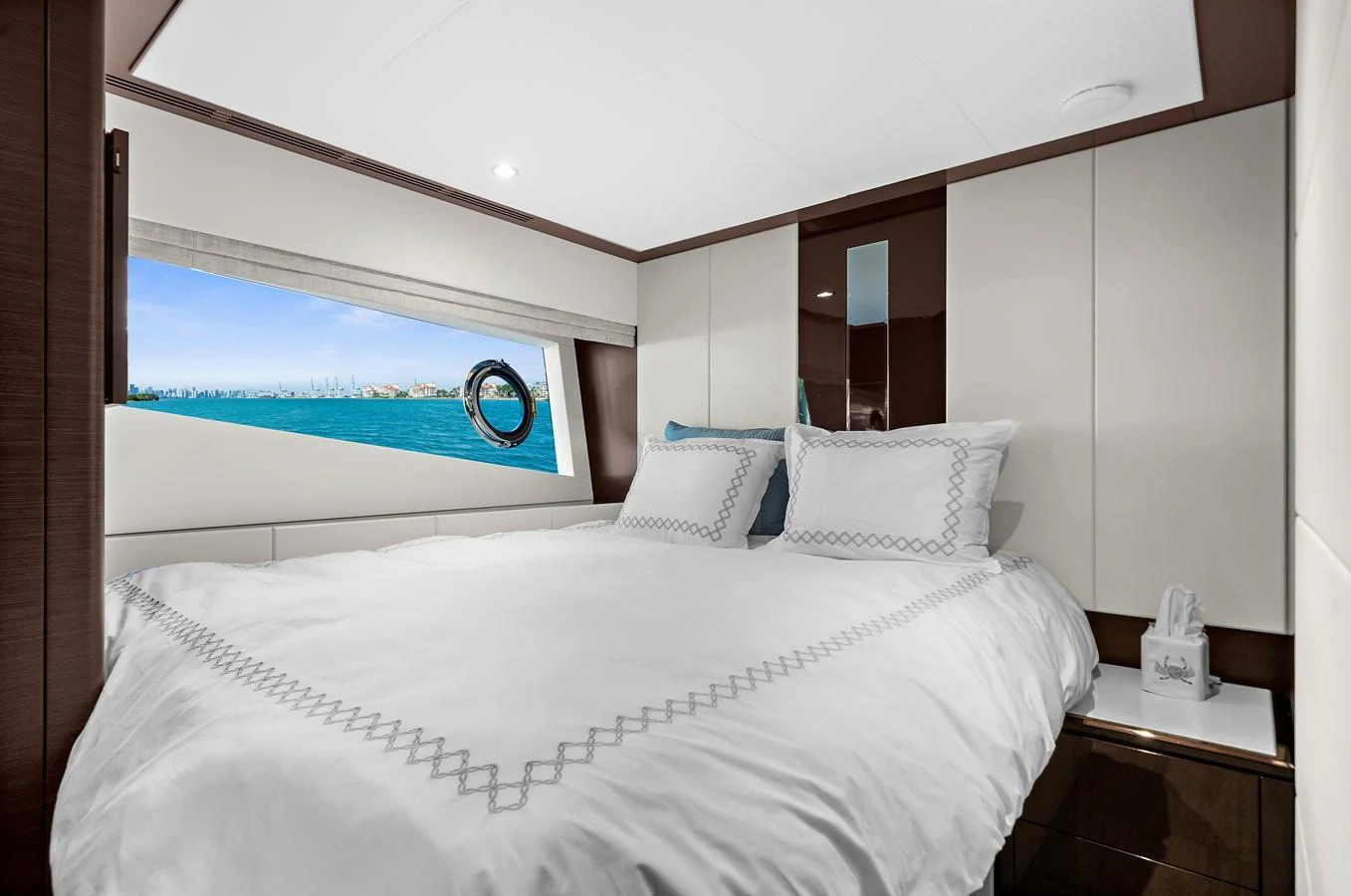 A cozy stateroom with a large bed and a scenic window view. aboard LA LA LA Yacht for Sale