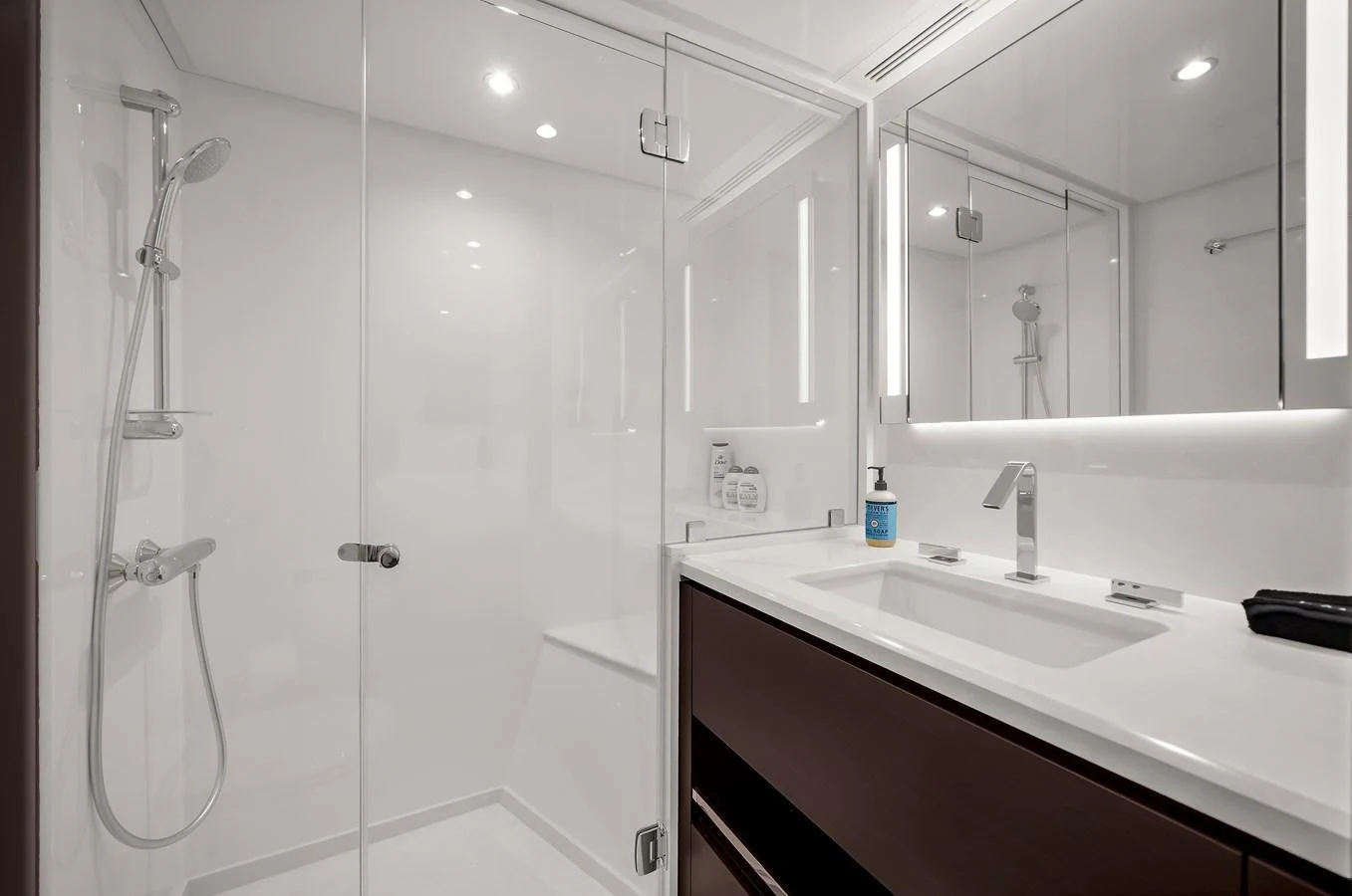 The yacht's bathroom features a sleek, modern design with a spacious shower and elegant fixtures. aboard LA LA LA Yacht for Sale