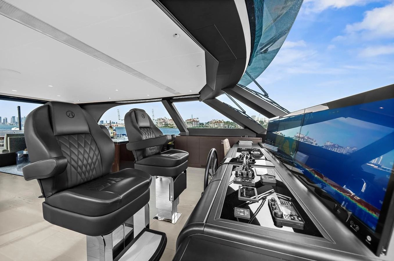 The helm station features luxurious seating and state-of-the-art navigation equipment with panoramic views. aboard LA LA LA Yacht for Sale