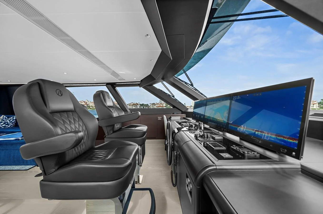 The helm station features luxurious seating and state-of-the-art navigation equipment with panoramic views. aboard LA LA LA Yacht for Sale