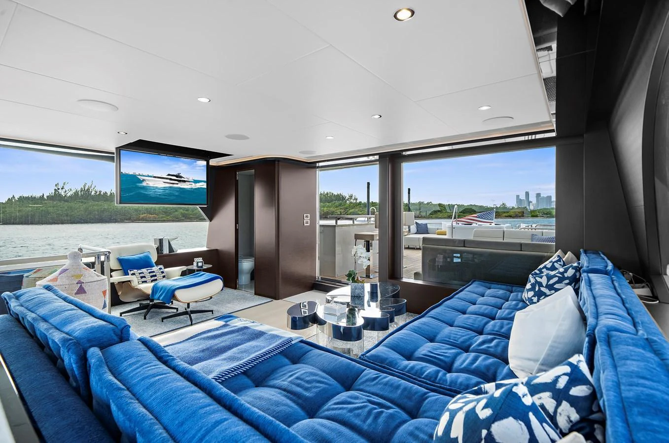 The salon features a spacious and stylish seating area with panoramic views of the water. aboard LA LA LA Yacht for Sale