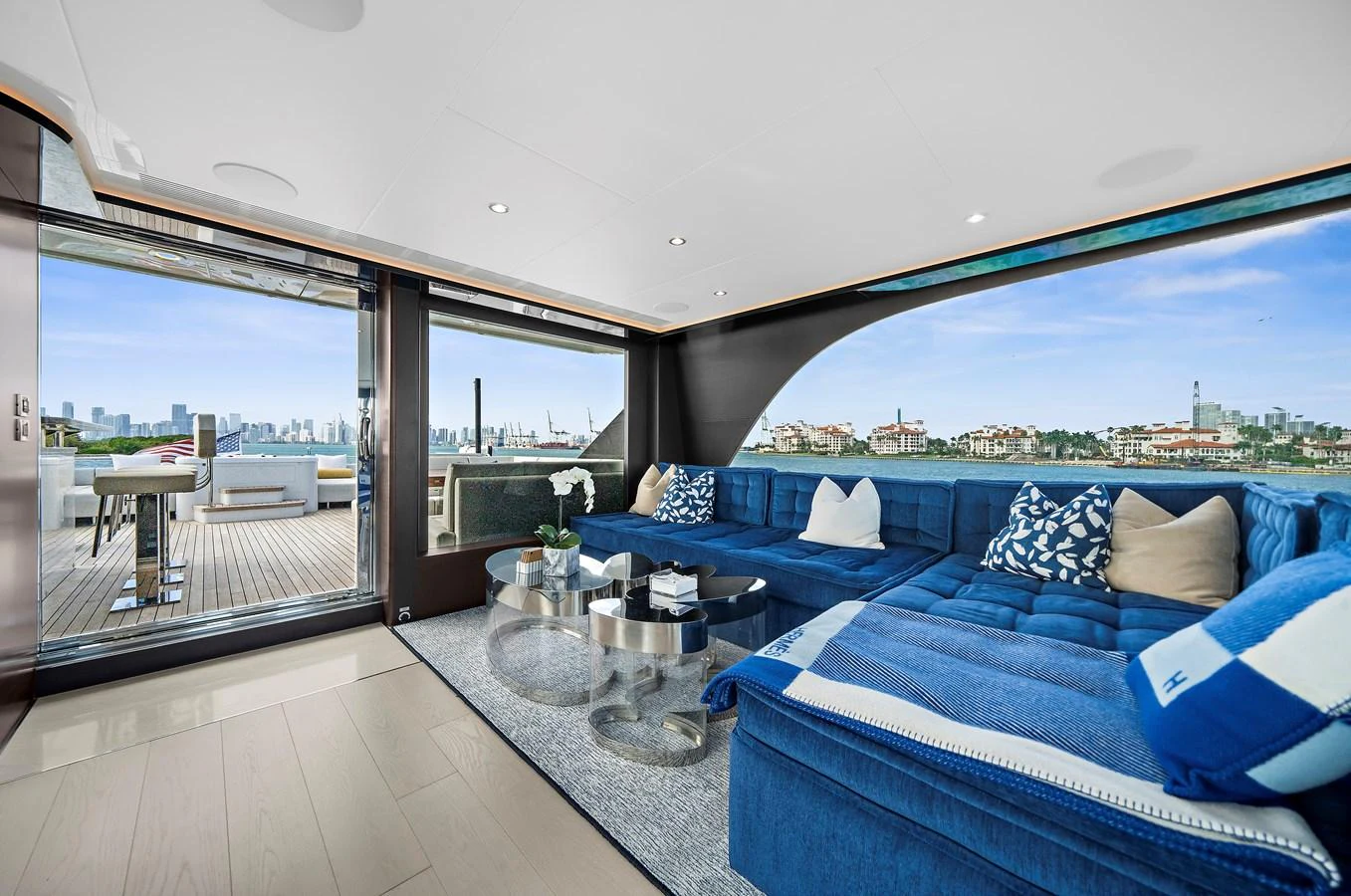 The salon features a spacious and luxurious seating area with panoramic views and direct access to the aft deck. aboard LA LA LA Yacht for Sale