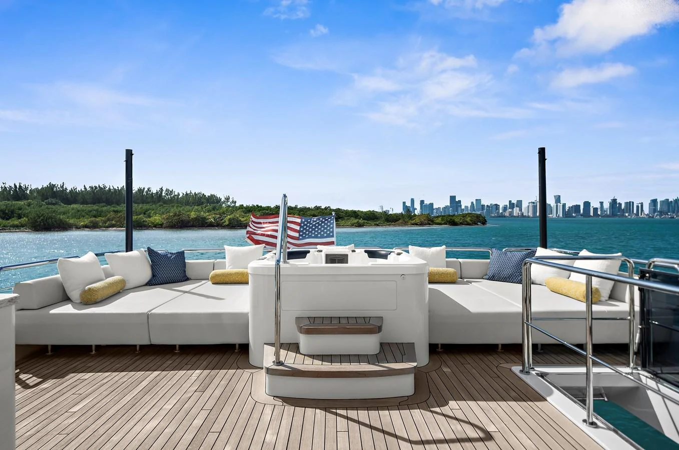 The aft deck features luxurious seating with a stunning view of the water and city skyline. aboard LA LA LA Yacht for Sale