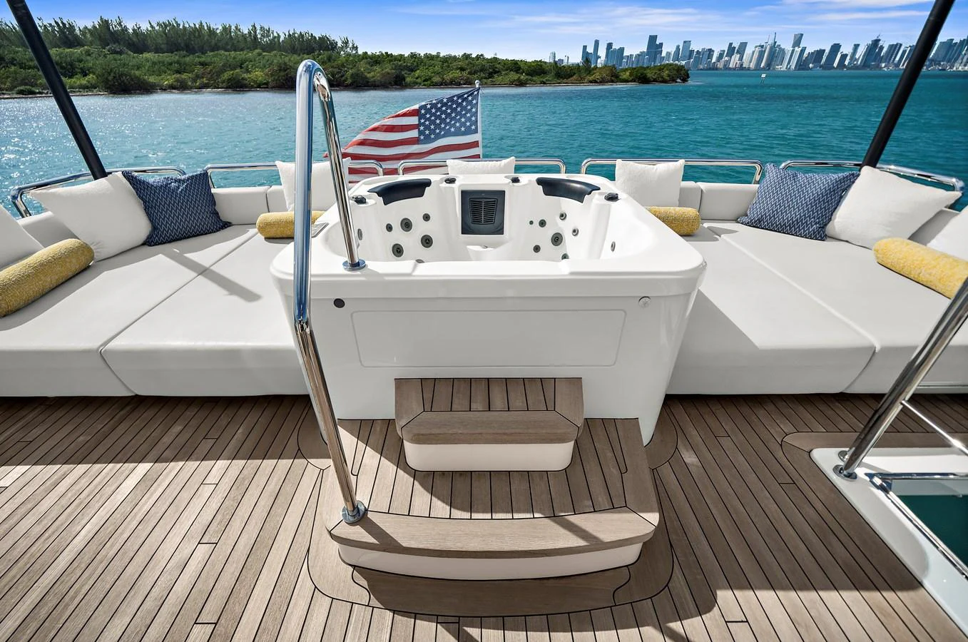 The sundeck features a luxurious hot tub with ample seating and stunning views of the water and city skyline. aboard LA LA LA Yacht for Sale