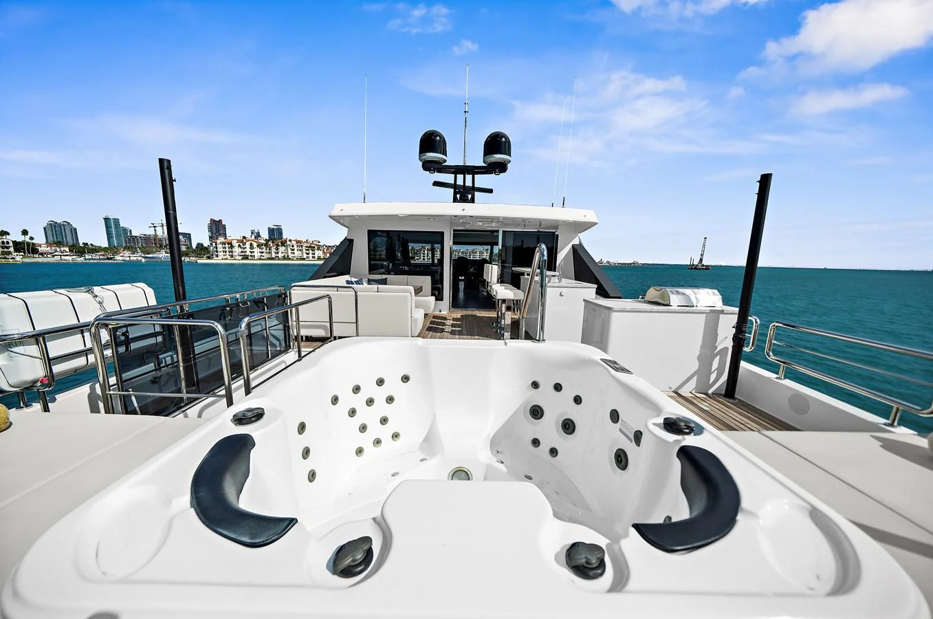 The sundeck features a luxurious jacuzzi with a stunning view of the surrounding waters. aboard LA LA LA Yacht for Sale
